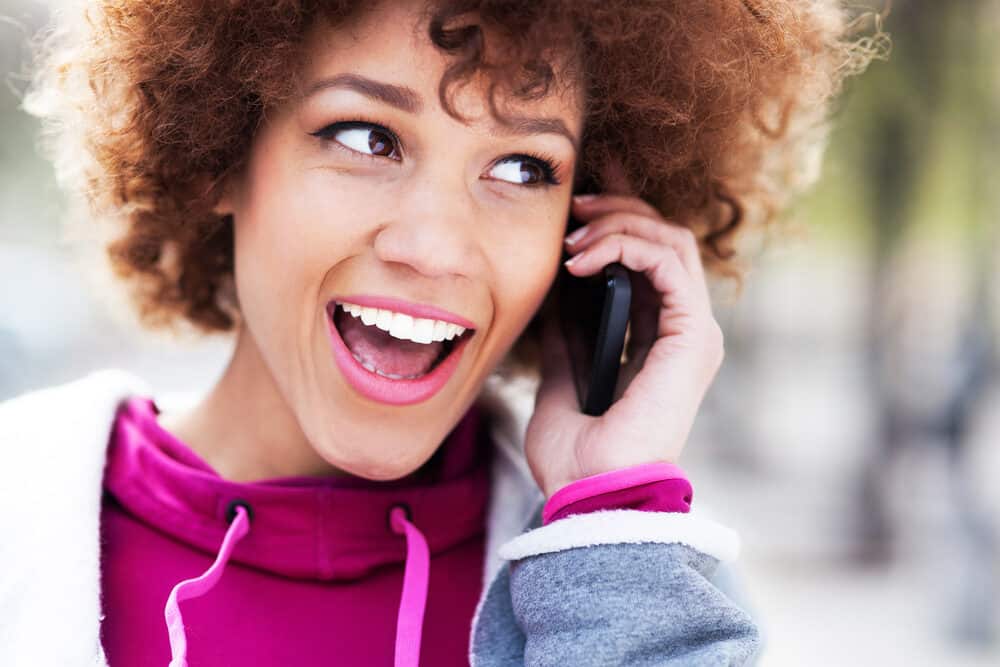 Lady wearing brown curly hair planning to dye her dark hair purple without harsh chemicals