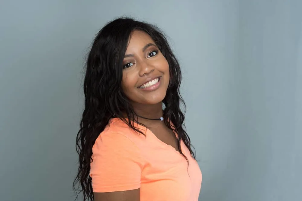 Are Dominican Hair Salons Good for Black Hair? Do They Damage Your Hair? 7 Lady of African Ancestry with a big smile and popular Dominican culture hairstyle