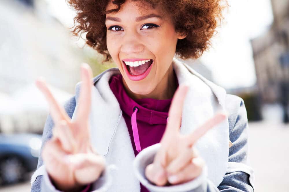 African American lady wearing casual clothes and permanent purple hair dye