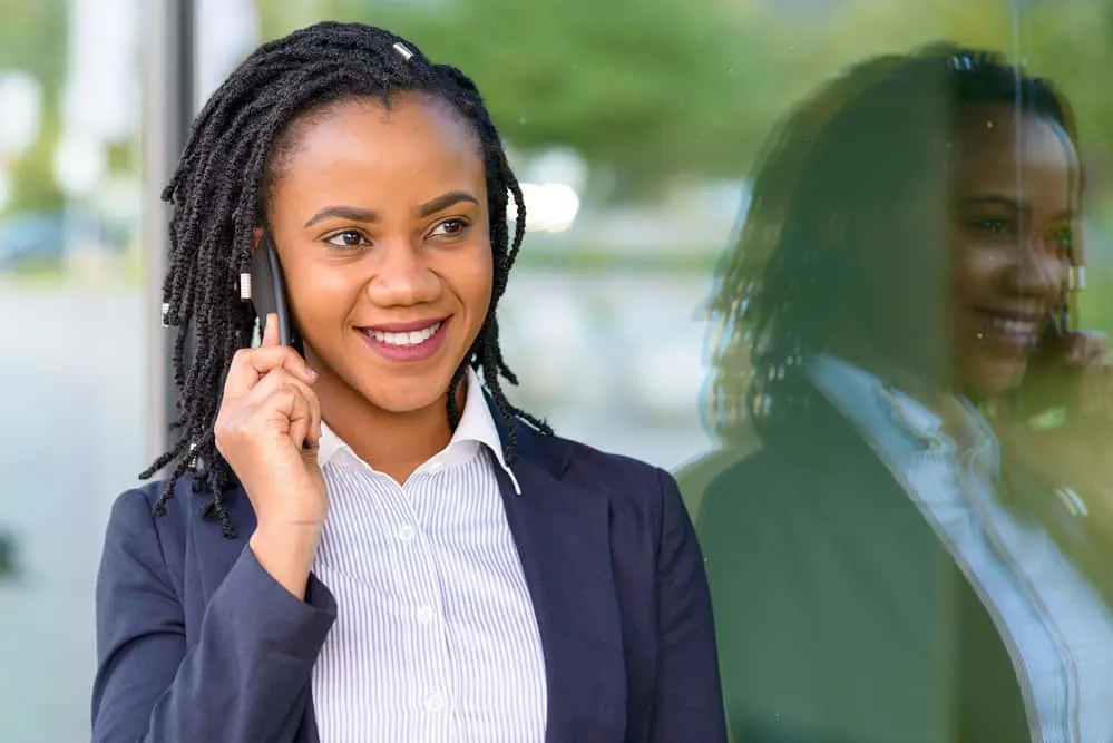 The 5 Different Stages of Locs: Baby, Budding, Teenage, Mature, and Rooted 7 Black girl talking on the phone wearing teenage phase weak locs