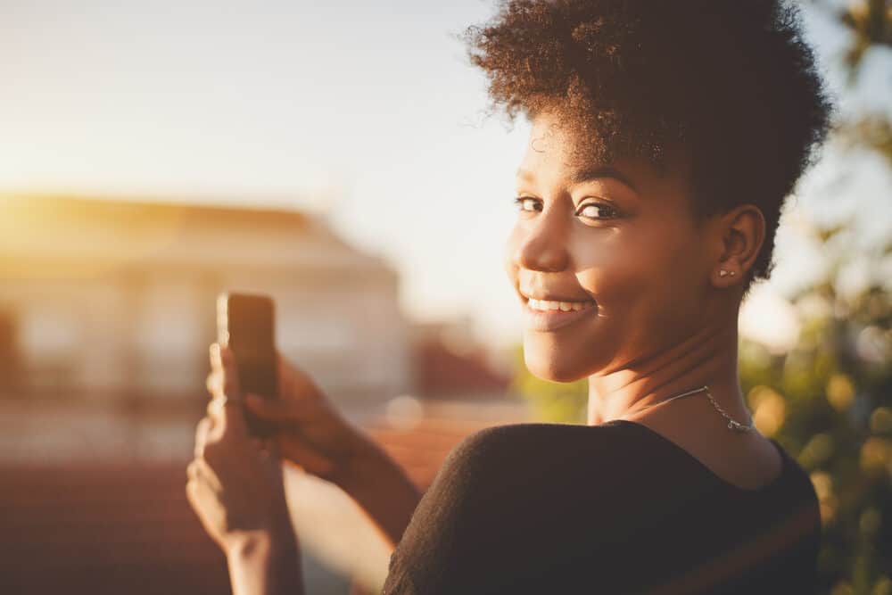 Black girl with curly hair looking back over her left shoulder