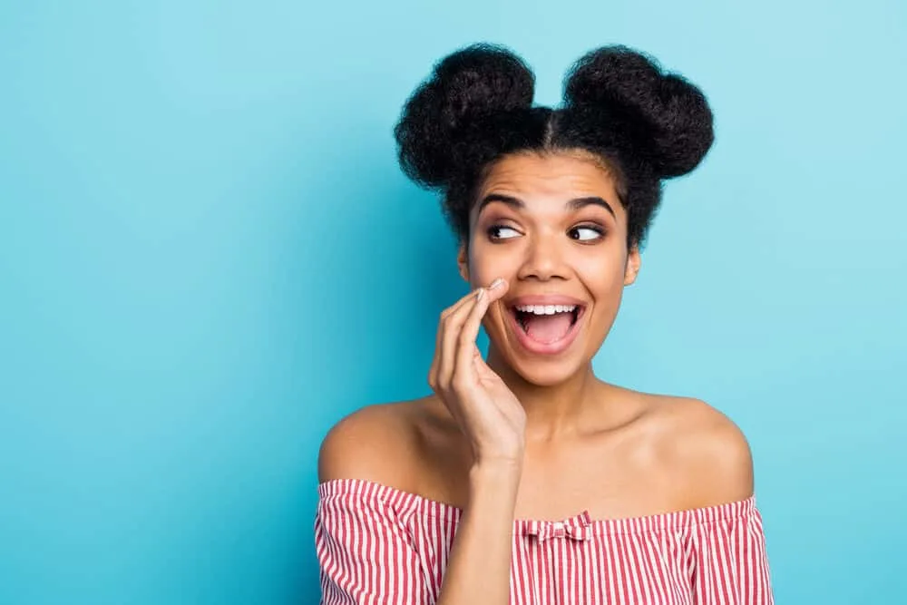 How to Do Space Buns: Easy, Step-by-Step Tutorial for Beginners 5 Black woman looking like Princess Leia with half down space buns with extra volume