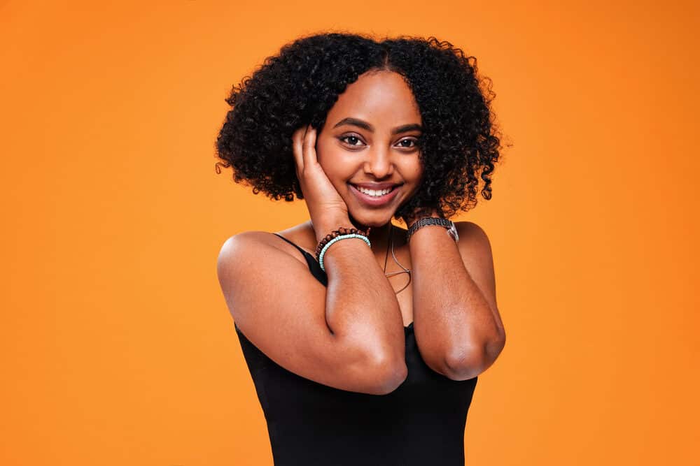 A confident, attractive black woman running her fingers through her hair