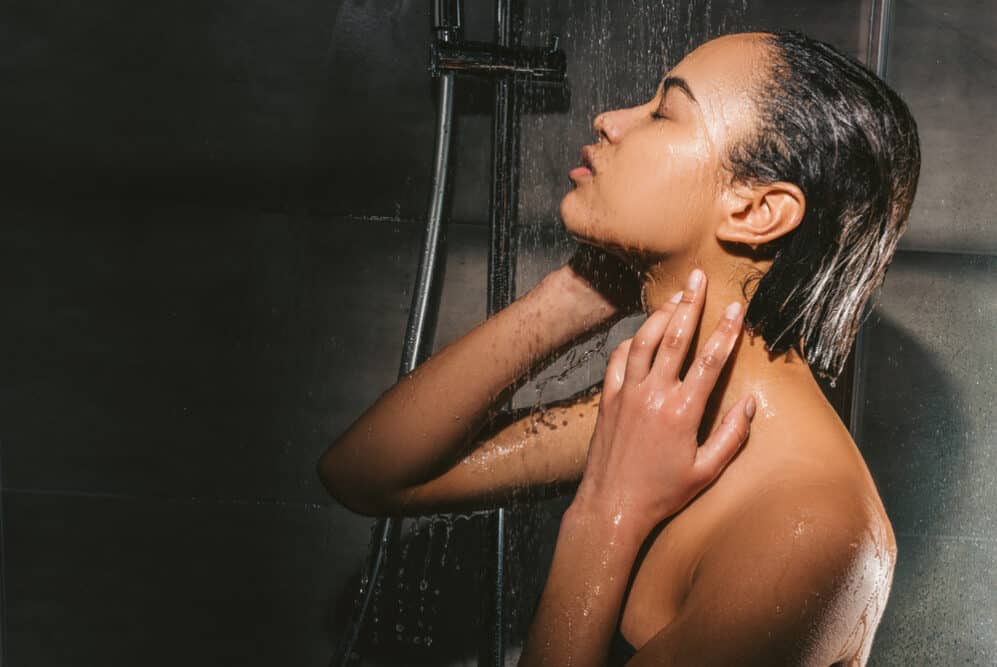 Black girl with sensitive skin comparing shampoo and body differences in the shower