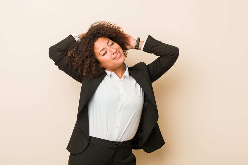 Black woman stretching in a professional outfit