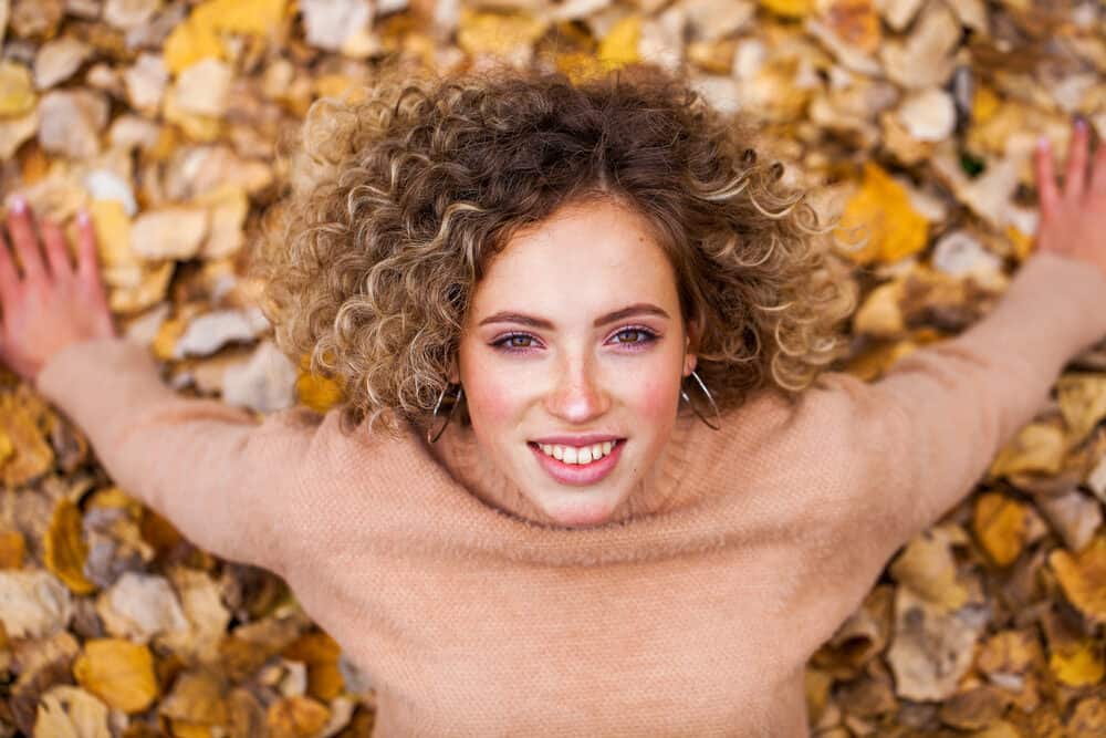 White girl with an American wave chemical treatment during an outdoor photoshoot