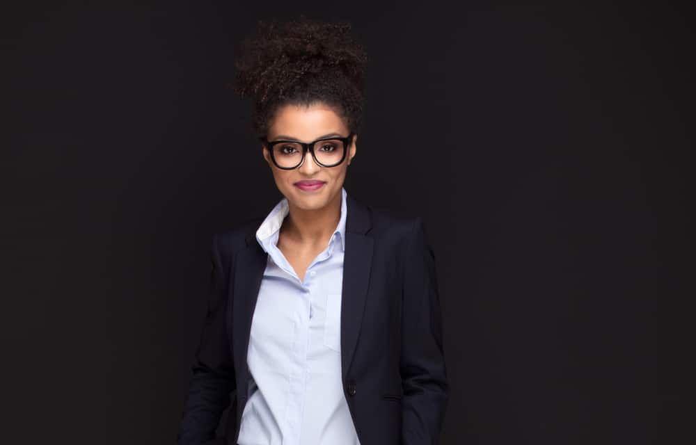 Cute young woman with short hair in a pineapple half-pony hairstyle