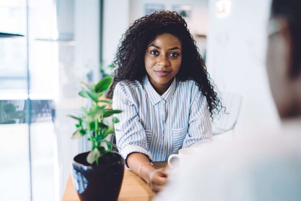 Confident African American girl with a normal woman's hair length touching her mid-shoulders