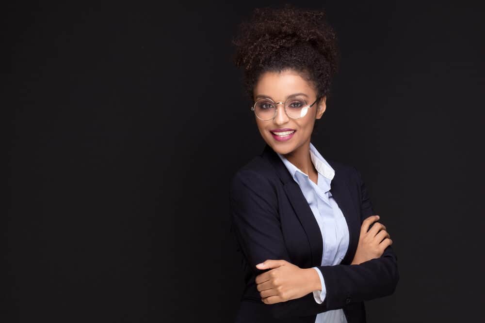 Cute girl wearing a blue professional outfit with loose waves and curls on short hair