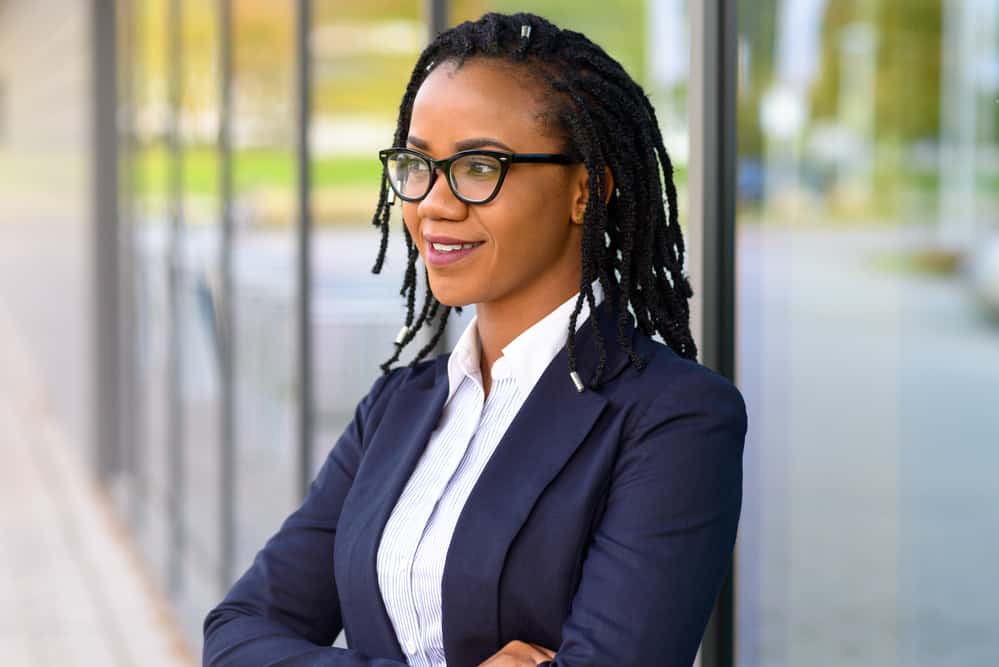 Black woman with loose natural hair started with comb coils