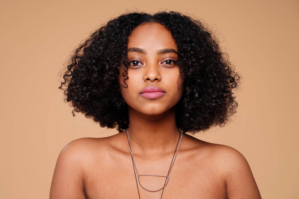 African American female with natural curls and caramel skin