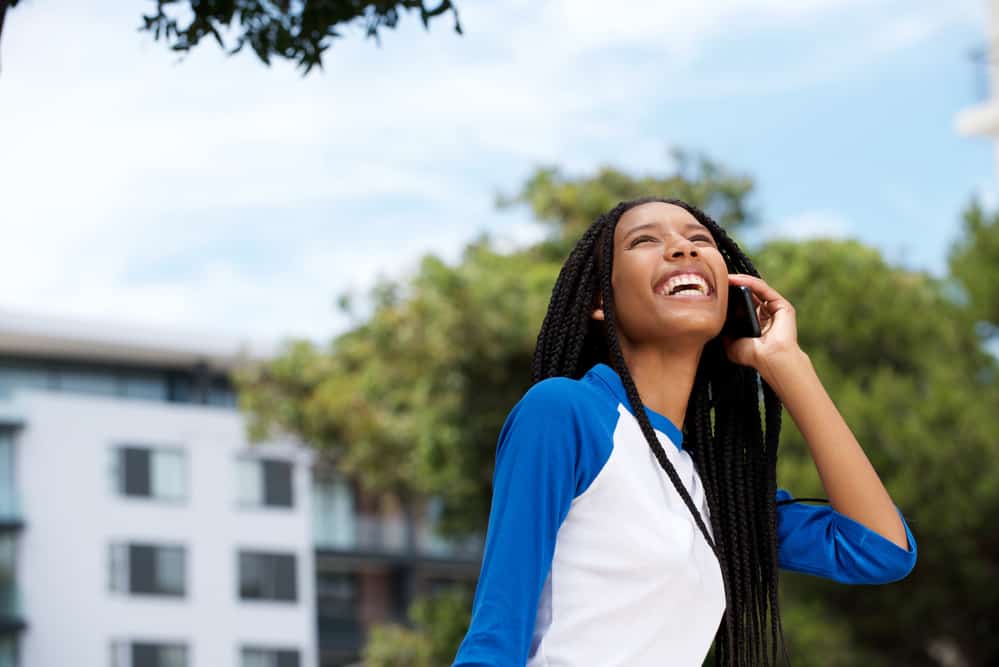 Cute black girl wearing a blue and white shirt during the summer with braided twists