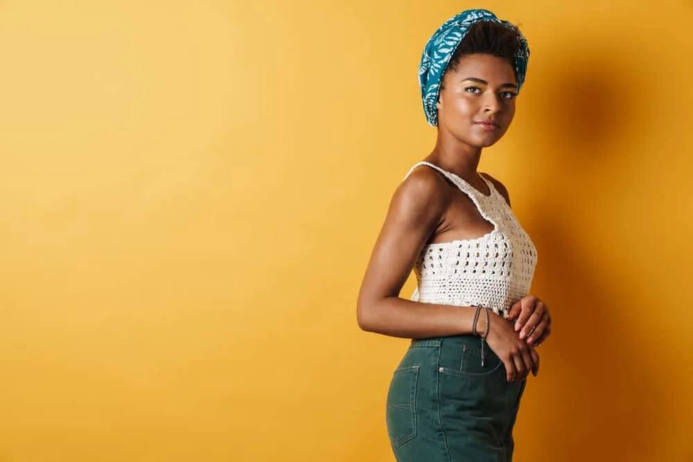 How To Get Dandruff Out of Curly Hair Quickly at Home 6 Young woman with an irritated scalp using a scalp scrub with anti-fungal properties under a headscarf
