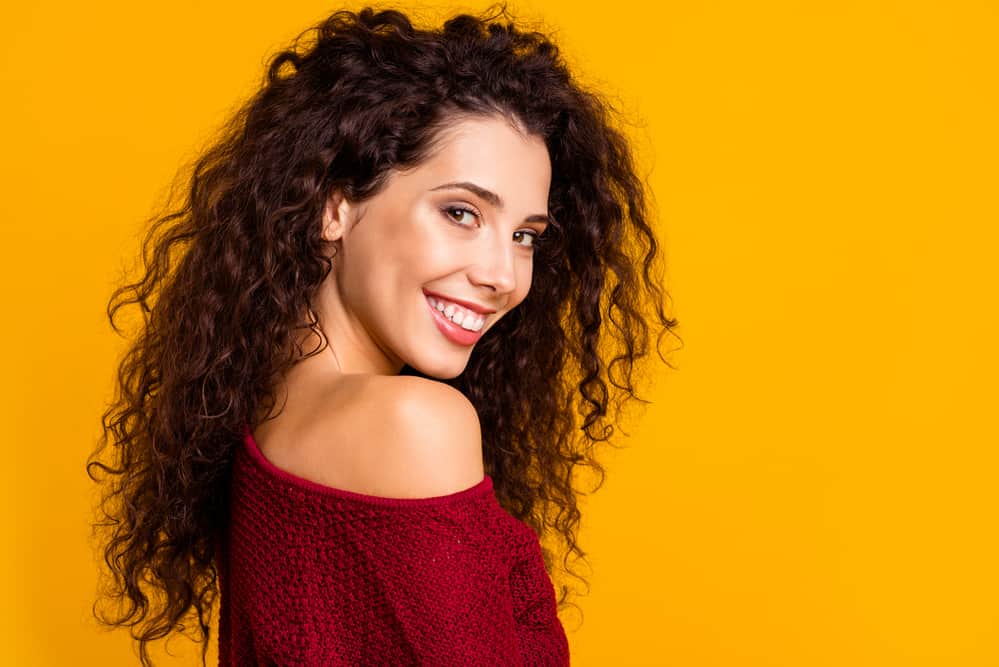 Cute white girl with permed hair showing off her wavy texture