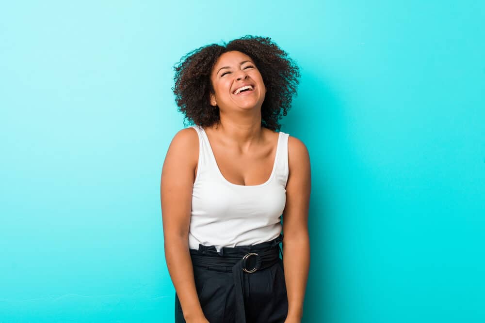 Cute African American woman with natural twists and a huge smile on her face