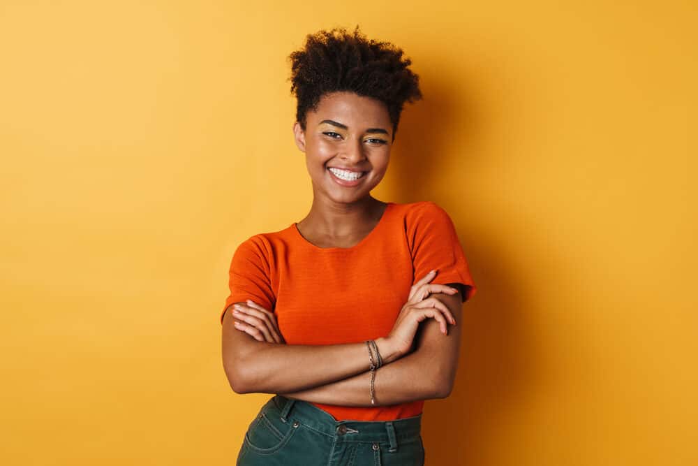 Are Silicones Bad for Hair? Curly Hair? Why? What Happens? 4 Female with curly dry hair smiling after washing her hair with a silicone-free shampoo