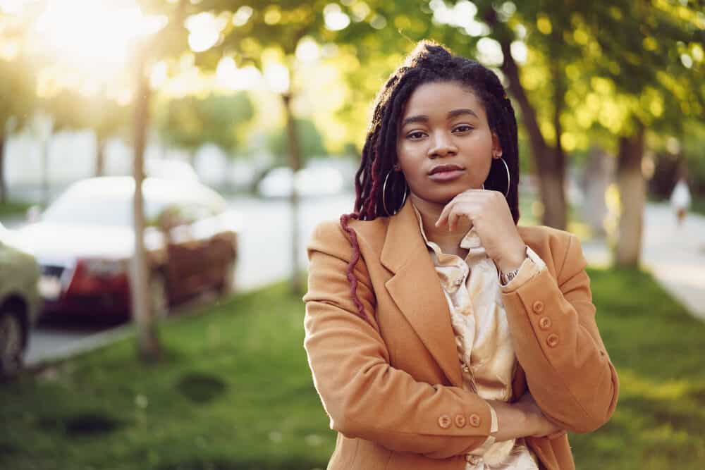 Black lady starting the locking process with her young dreadlocks