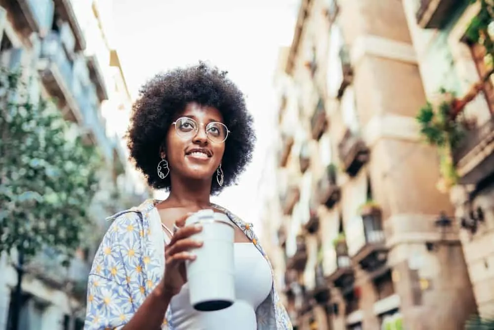 The 4 Best Hair Growth Products For African American Hair Types 13 Young lady drinking tea posing for a photo after using a sulfate-free shampoo