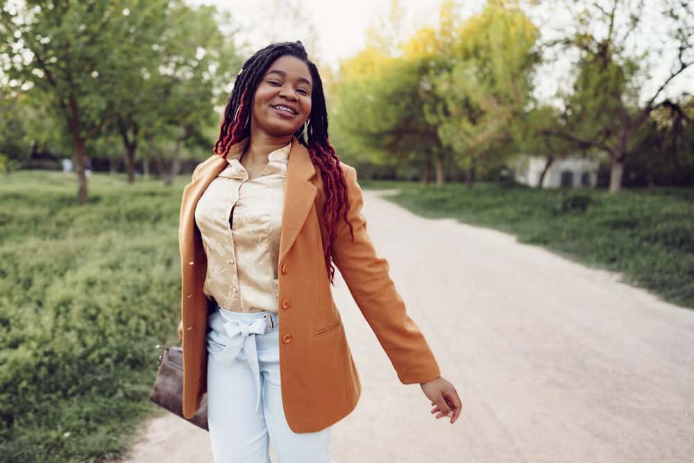 Stylish African American girl with loc extensions wearing smaller locs with red tips