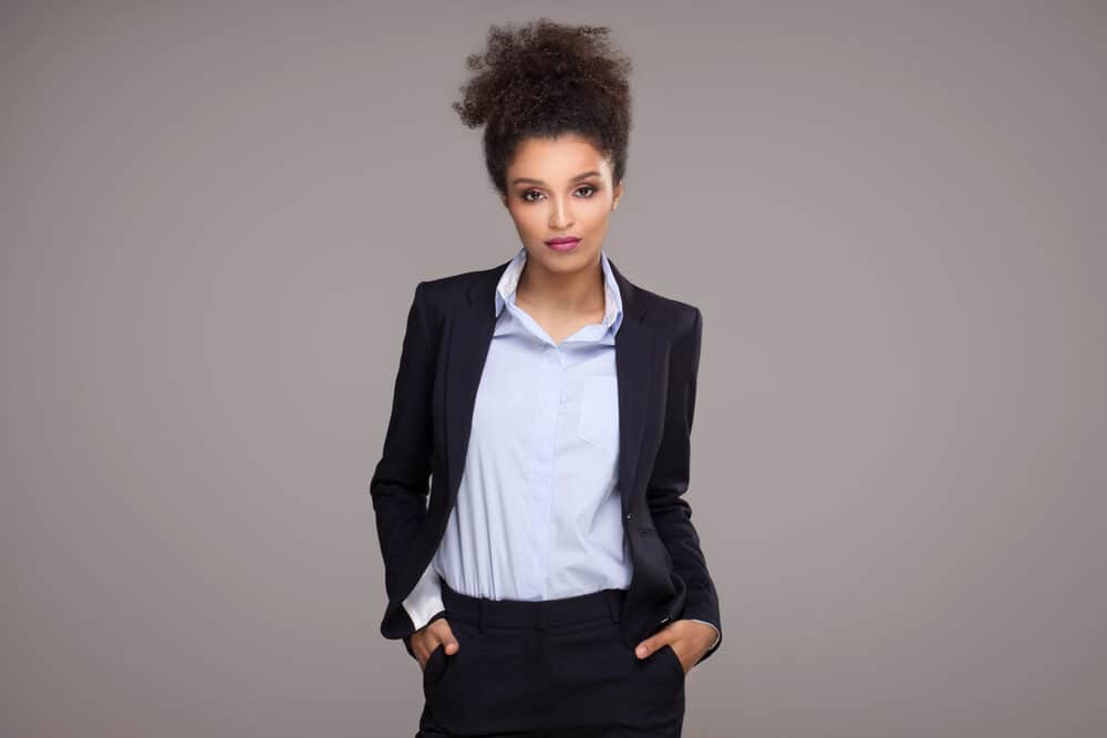 Black lady with polished look with shoulder-length hair in a curly hairstyle