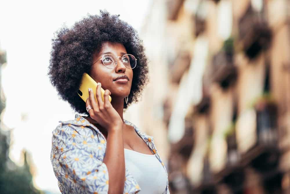 Young black girl promoting hair growth with her 4c curls in a wash and go hairstyle