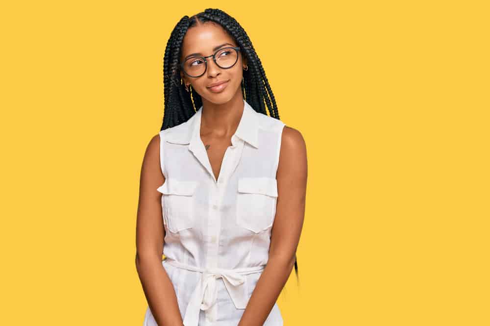 Cute African American female with box braids installed using the feed-in technique