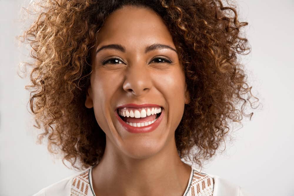 Cute African American woman wearing curls on her own hair