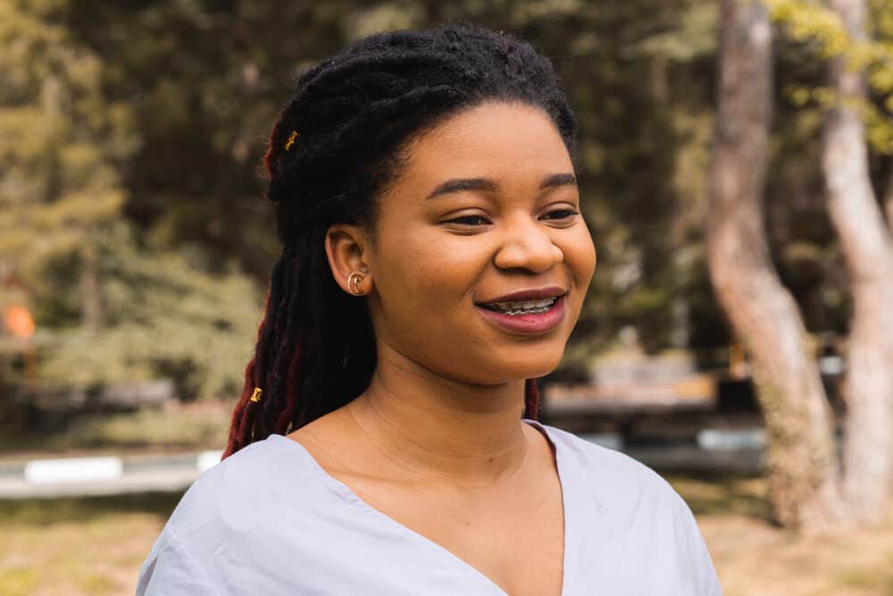 A young African American woman with mature locs on 4C coarse hair strands