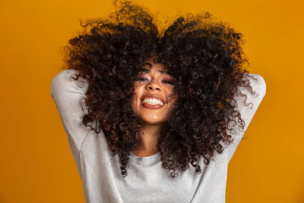 Cute African American female wearing clip-in extensions