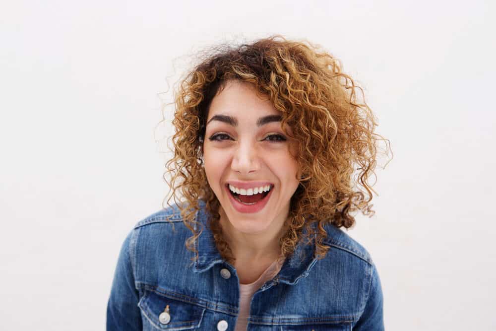 Young white woman with wavy ombre dark hair after using a deep moisturizing treatment