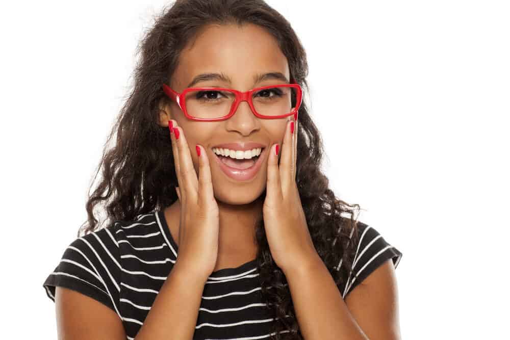 Dark-skinned lady with DIY Bellami hair extensions typically done by a hair stylist