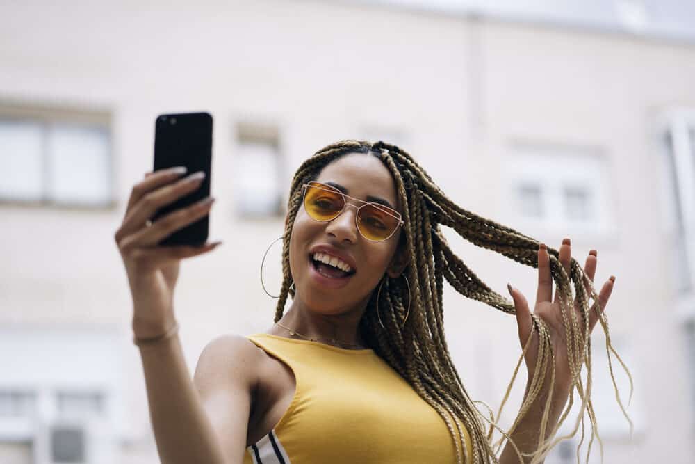 Cute African-Latin female wearing synthetic hair braided in box braids