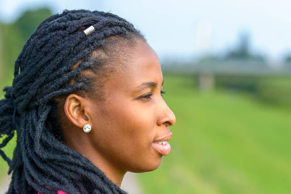 Young black girl with dreads that let her hair wet creating a breeding ground for mold