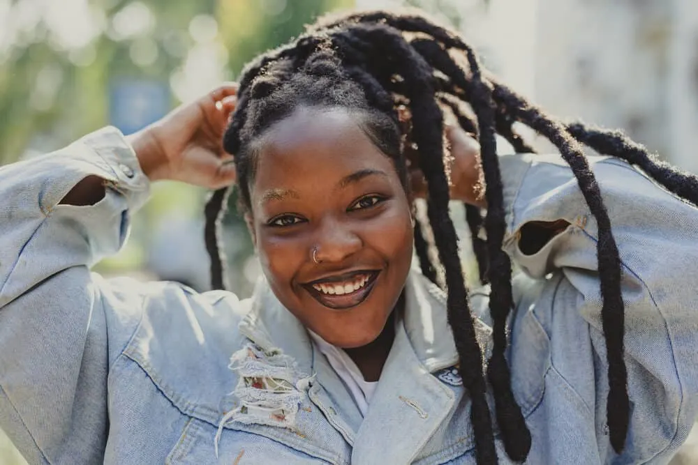 How To Start Wick Dreads Using the Crochet, Freeform, and Rubber Band Methods 4 Black woman with a nose ring and wick dreadlocks created with a crochet hook and the combine method