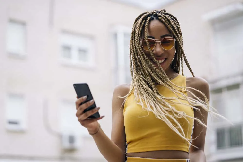 How To Fix Frizzy Braids and Keep Braids From Frizzing Up 6 Pretty African girl with braided stretched hair wearing a yellow casual outfit