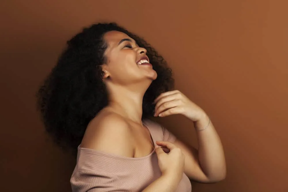 The Benefits of Using Horse Shampoo on Human Hair for Growth, Thickness, and More 4 Light-skinned black lady with a type 3C human hair type wearing casual clothes