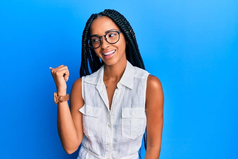 Female with light-weight jumbo knotless braids on brown and black hair