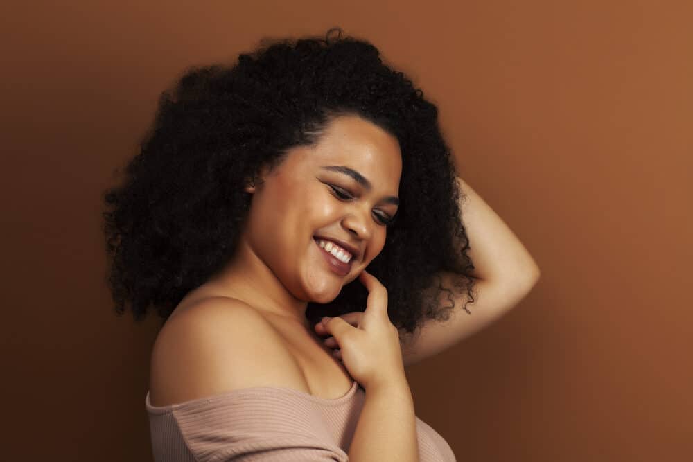 Gorgeous black girl with a huge smile posing for a photo after using Mane N Tail shampoo