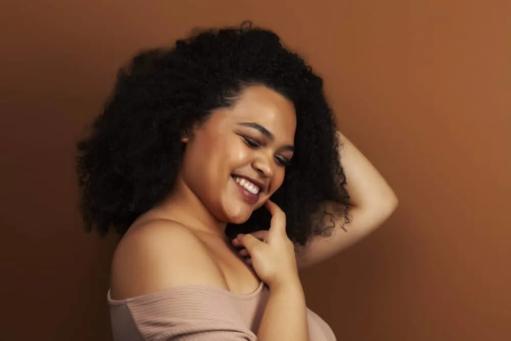 The Benefits of Using Horse Shampoo on Human Hair for Growth, Thickness, and More 2 Gorgeous black girl with a huge smile posing for a photo after using Mane N Tail shampoo
