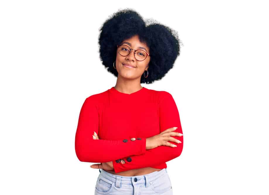 Black girl wearing glasses after using the right shampoo to mitigate frizz