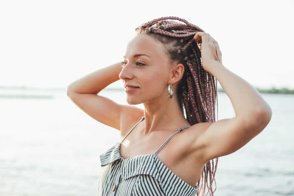 Young woman with thin caucasian hair wearing braiding hair extensions