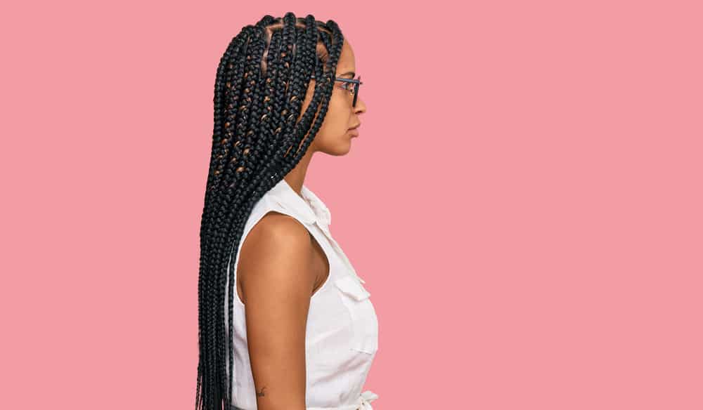 Cute African American female wearing an ombre braided hairstyle called small knotless braids