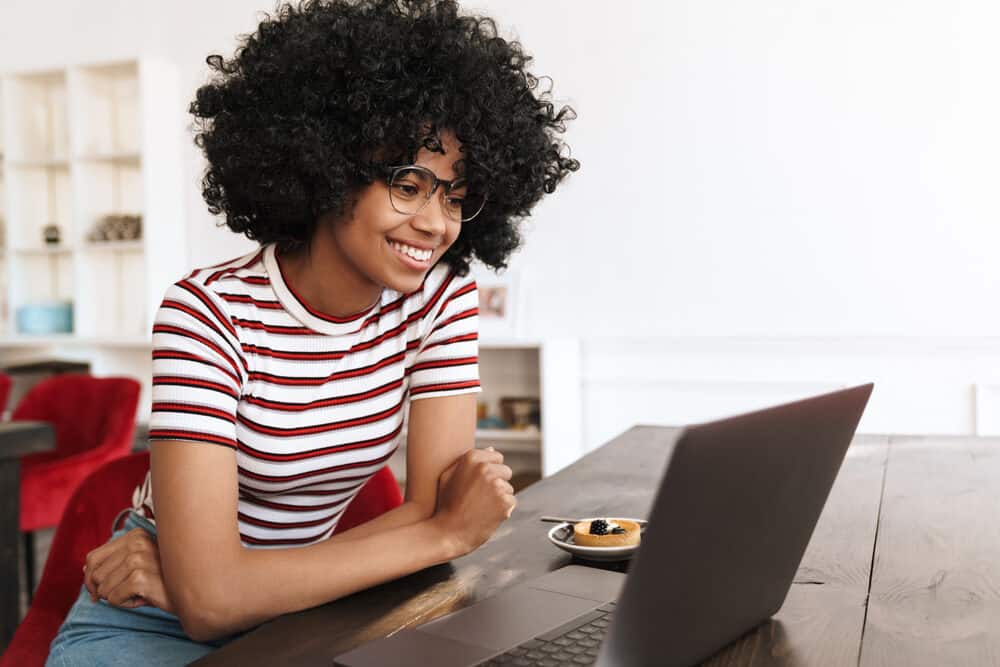 African American lady with black natural hair styled with warm air from a handheld dryer