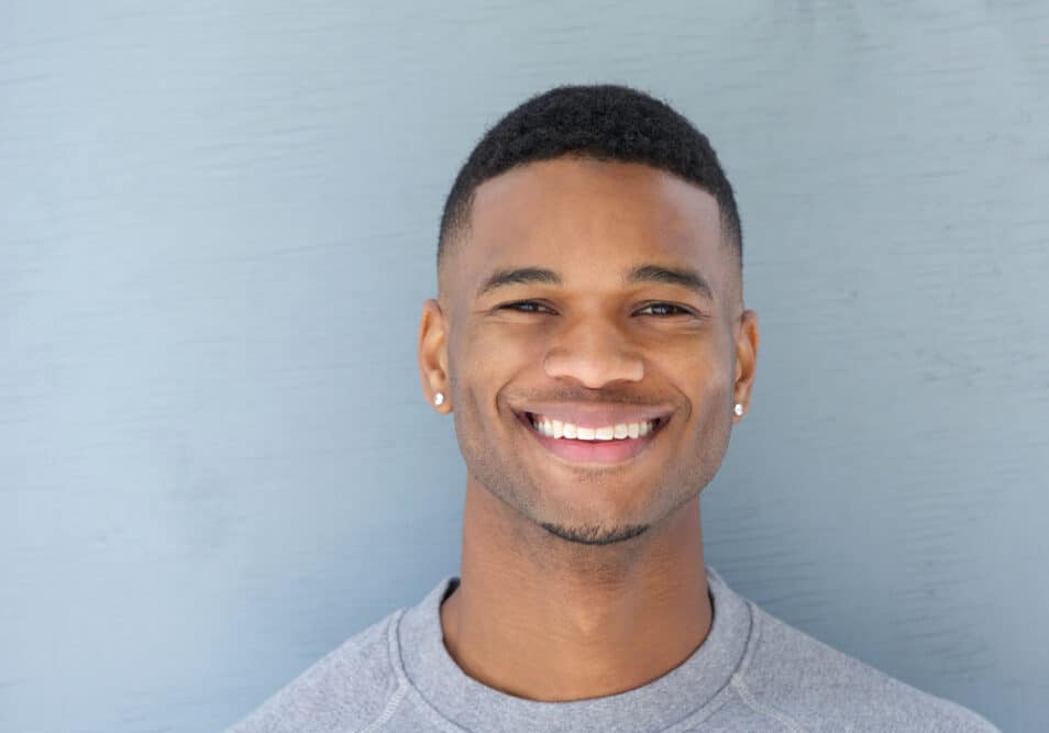 7 Best Edgers for Black Hair: Top Hair Clippers & Hair Edgers 1 A handsome young black man with thick hair used a cordless trimmer with self-sharpening blades and an Andis T-outliner to trim his coarse hair strands.