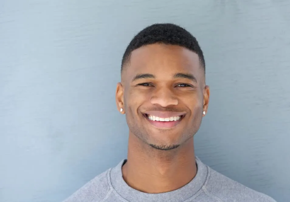 7 Best Edgers for Black Hair: Top Hair Clippers & Hair Edgers 1 A handsome young black man with thick hair used a cordless trimmer with self-sharpening blades and an Andis T-outliner to trim his coarse hair strands.