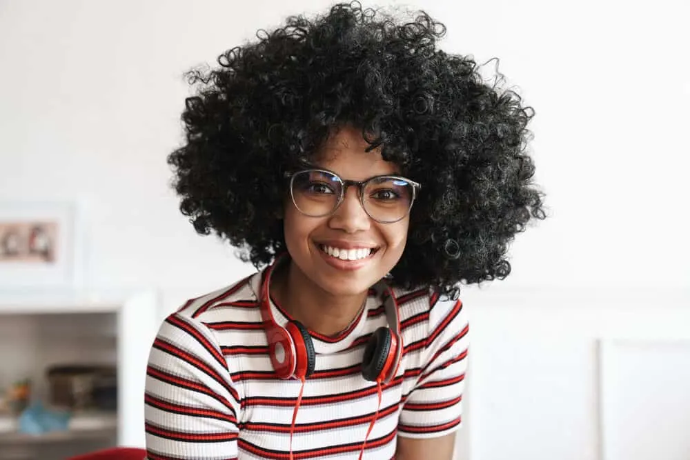 Best Hooded Hair Dryer for Home Use for Natural Black Hair 1 Cute African American hair model with big curls created from jumbo rollers and a hood dryer
