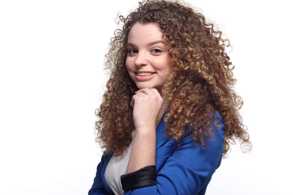 White girl with soft curls with great body wearing a blue business suit