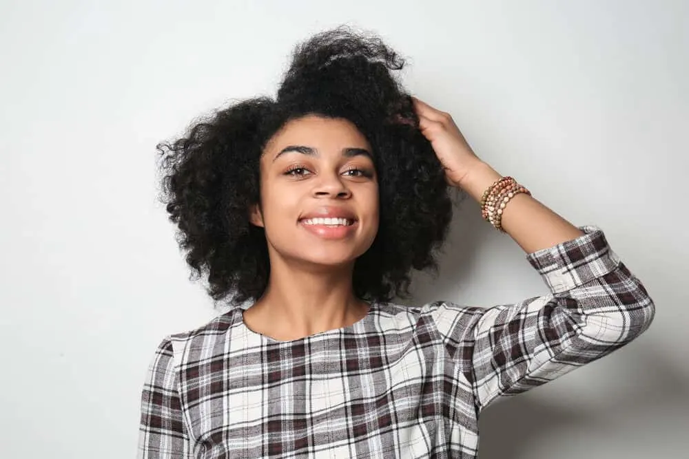 Do Hair Products Expire? Can You Use Expired Hair Products? 4 African American women smiling while wearing a red, white, and black dress.