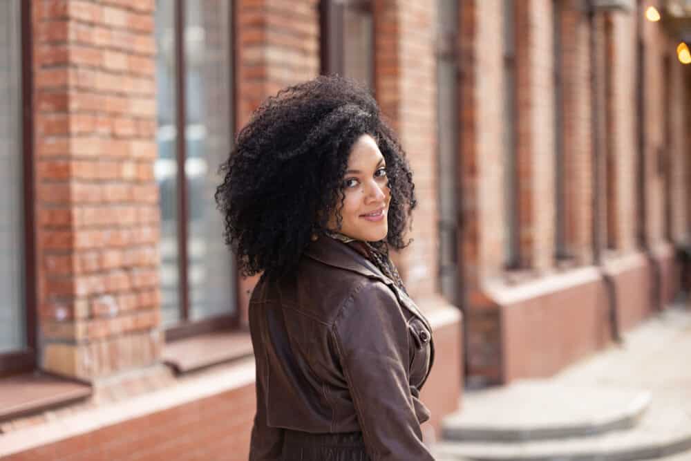 Cute black girl with flat hair washed with Aussie shampoo and styled with jojoba oil