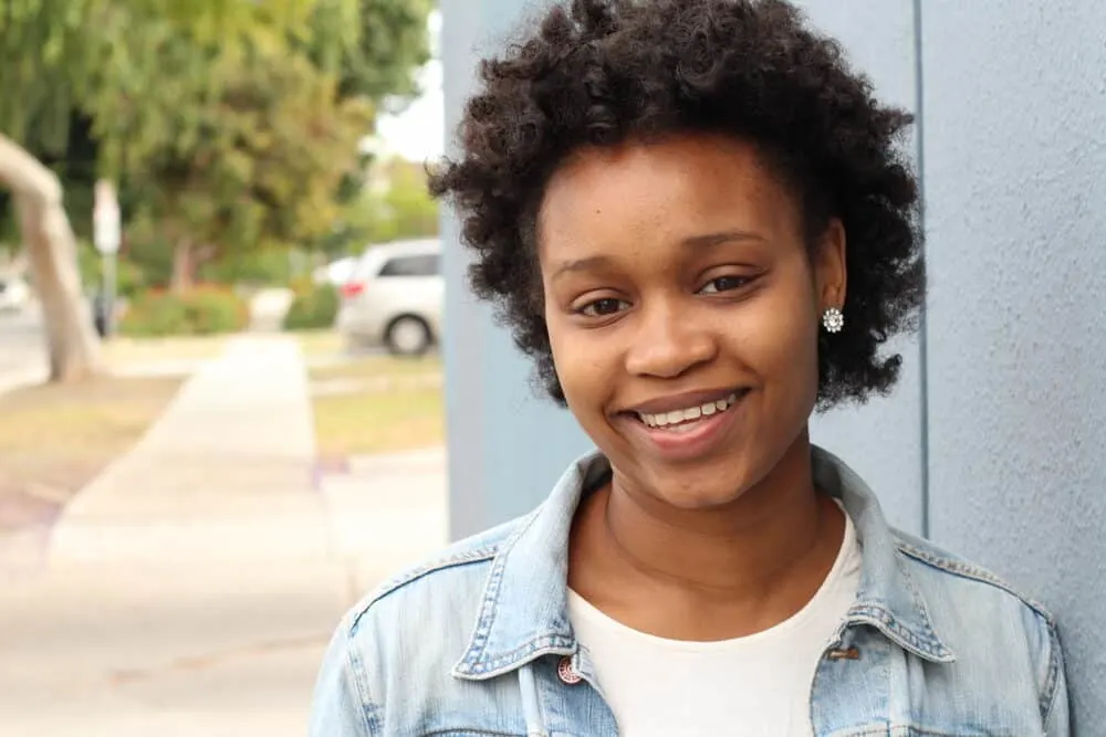 Do Black People Wash Their Hair? How Often Do They Wash? 3 Black girl wearing 2-carat diamond earrings from Diamonds Direct
